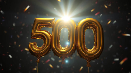 500 gold party balloons with confetti and bright lightsの素材