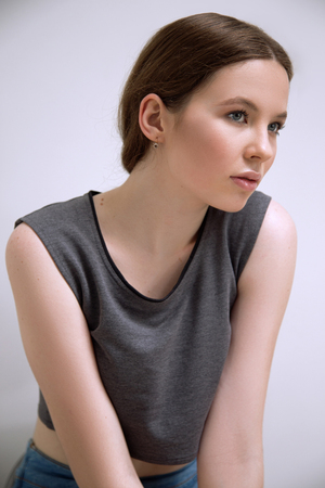 Brunet cheerful young woman. Beauty portrait, perfect makeup. Long chic elegant hair. Model tests. Young girlの写真素材