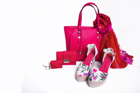 Modern women's pink bag, purse, sandals and scarf on white background isolatedの写真素材