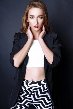 Fashion photo of young woman on black background. Girl posing. Studio photo.の写真素材