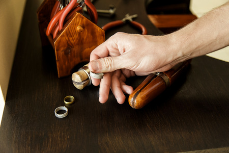 The jeweler chooses the shape for making the ring. Workspace close-upの写真素材