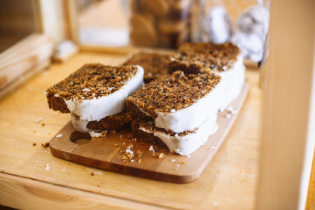 Homemade pie with raisins and glaze on a wooden cutting board