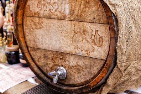 Festival of street food. A wooden barrel with wine sold outdoors in the local market.の写真素材