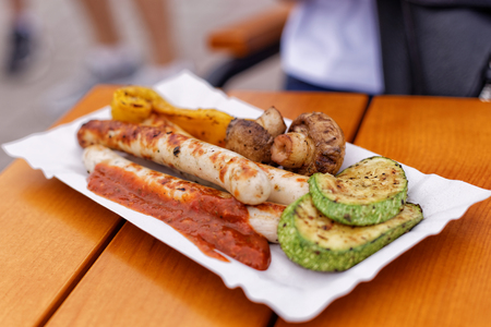 Festival of street food. Grilled sausages and vegetables outdoors in the local market.の写真素材