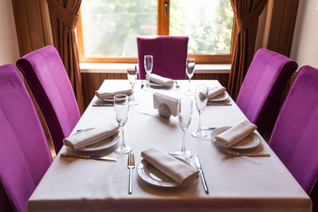 Table setting for the holiday, white tablecloth dishes and appliances on the table in the restaurant...