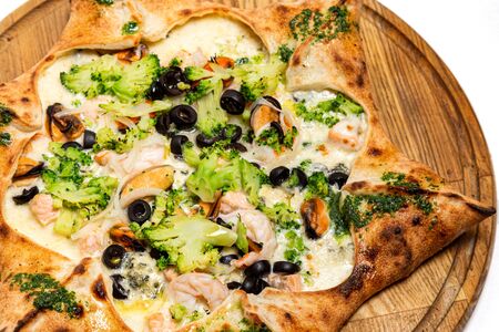Star shaped pizza with cheese and seafood isolated on a white backgroundの写真素材