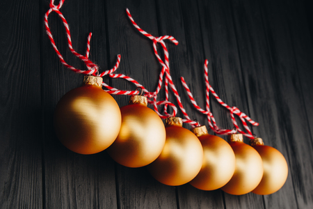 Colored christmas decorations on black wooden table. Xmas balls on wood background. Top view, copy space. new yearの写真素材