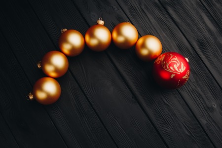 Colored christmas decorations on black wooden table. Xmas balls on wood background. Top view, copy space. new yearの写真素材