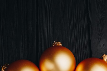 Colored christmas decorations on black wooden table. Xmas balls on wood background. Top view, copy space. new yearの写真素材