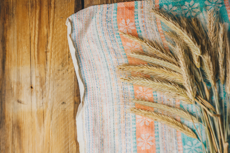 Spikelets on a towel in a rustic style on a white wooden tableの写真素材