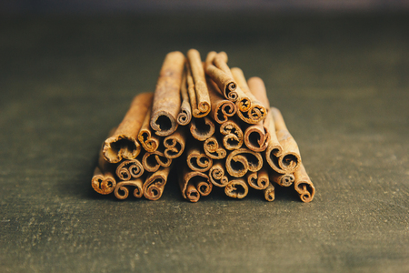 a bunch of whole sticks of fragrant cinnamon on a wooden rural table. copyspace. composition of seasoning and slide flavoring aromatic spice. close-up. top view.の写真素材