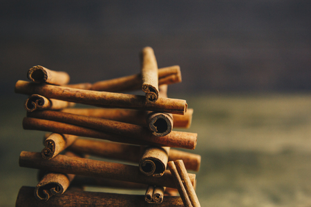 tower of whole sticks of fragrant cinnamon on a wooden rural table. copyspace. composition of seasoning and slide flavoring aromatic spice. close-up. side view, macro.の写真素材