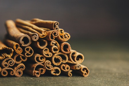 a bunch of whole sticks of fragrant cinnamon on a wooden rural table. copyspace. composition of seasoning and slide flavoring aromatic spice. close-up. front view.の写真素材