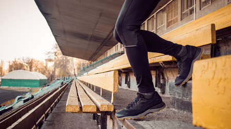 Caucasian man trains in running on the stairs. Track and field runner in sport uniform training outdoor. athlete, top view. step exercise. steps down.の写真素材