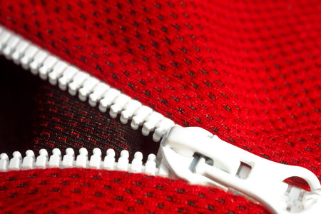 red sportswear closeup top view. white zip line. breathable knitwear. clothing details macro.