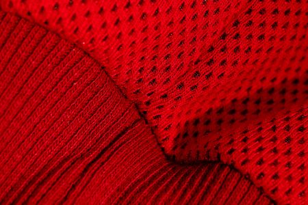 red sportswear closeup top view. seam and juncture. breathable knitwear. clothing details macro.の写真素材