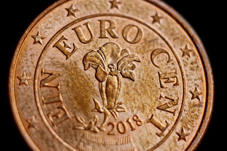 Reverse side of the coin one euro cent macro isolated on black background. Detail of metallic money...
