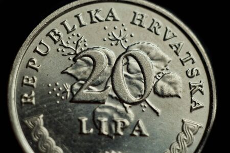 coin twenty croatian lipa macro isolated on black background. Detail of metallic money close up. money of european country croatia.の写真素材