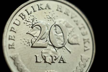 coin twenty croatian lipa macro isolated on black background. Detail of metallic money close up....