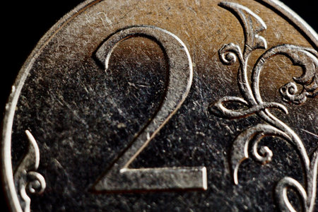 Coin two Russian rubles macro isolated on black background. Detail of metallic money close up. money...