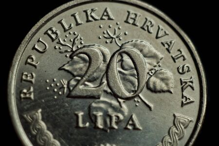 coin twenty croatian lipa macro isolated on black background. Detail of metallic money close up. money of european country croatia.の写真素材
