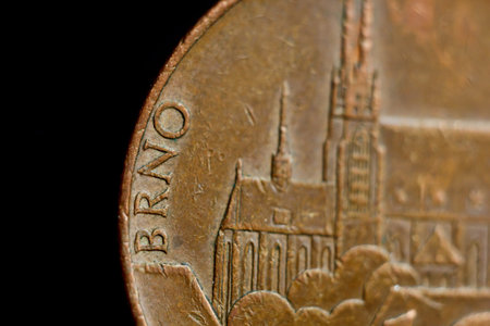 Coin ten Czech koruna macro isolated on black background. Detail of metallic money close up....