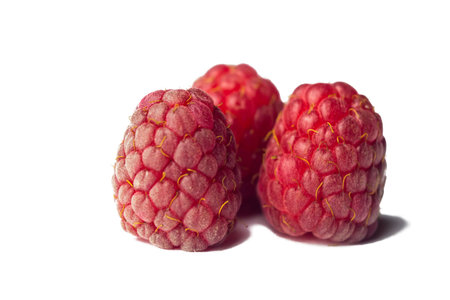red raspberry berries close-up isolated on a white background. sweet summer medicinal berries macro...