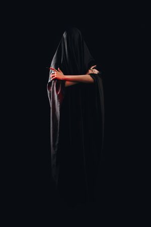 a girl with long hair in the image of a witch is trying to set herself on fire. rituals with candles for love spell and damage. expulsion of a bad spirit from the body.の写真素材