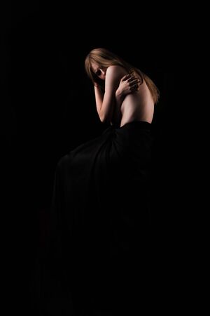 A girl with a bare back, severe thinness and protruding ribs. The concept of anorexia and bulimia, a disease of thin people. The struggle of the evil spirit in a girl, suffering and povertyの写真素材