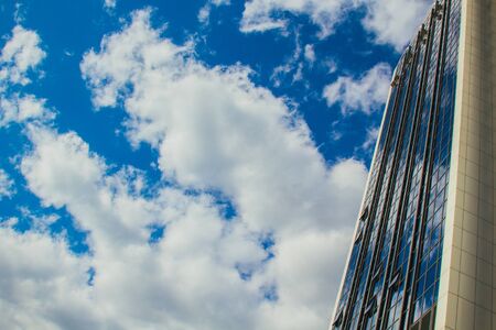 A skyscraper with lots of windows against a beautiful blue sky. Business and financial conceptの写真素材