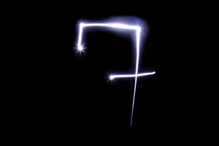 Set of numbers from neon light on a black background. Isolated top view, number 7の写真素材