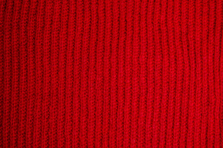 Pattern of colorful knitted sweaters closeup. Handmade merino wool product. Knitting patterns