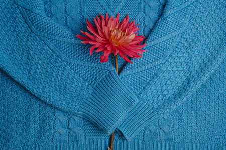 Pattern of colorful knitted sweaters closeup. Handmade merino wool product. A stack of folded...