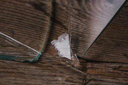 Broken glass on an old wooden floor, concept of violence