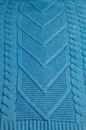 Pattern of colorful knitted sweaters closeup. Handmade merino wool product. Knitting patterns