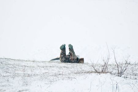 Two friends have fun and enjoy the fresh snow on a beautiful winter day. Snowfall falling in the snowの写真素材