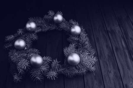 Colored christmas decorations on black wooden table. Xmas balls on wooden background. Top view, copy space. new year. Color of the year 2020 classic blue. Fashionable pantone color trend conceptの写真素材