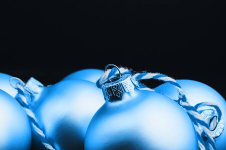 Colored christmas decorations on black wooden table. Xmas balls on wooden background. Top view, copy space. new year. Color of the year 2020 classic blue. Fashionable pantone color trend conceptの写真素材
