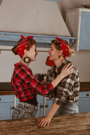 Family, friendship and people concept - happy mother with little daughter. With red lips in a...