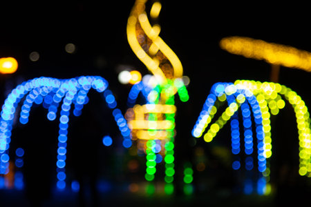 Golden abstract yellow, orange bokeh lights isolated on black background with copy space. Holiday...