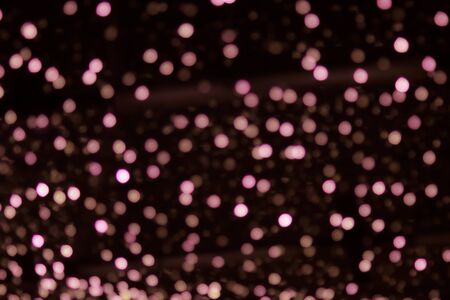 Golden abstract yellow, orange bokeh lights isolated on black background with copy space. Holiday and Christmas season concept, graphic resources, greeting card. wallpaper. Multi-colored lightsの写真素材