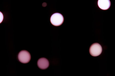 Golden abstract yellow, orange bokeh lights isolated on black background with copy space. Holiday and Christmas season concept, graphic resources, greeting card. wallpaper. Multi-colored lightsの写真素材