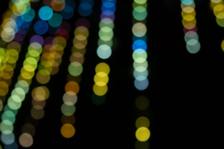 Golden abstract yellow, orange bokeh lights isolated on black background with copy space. Holiday...