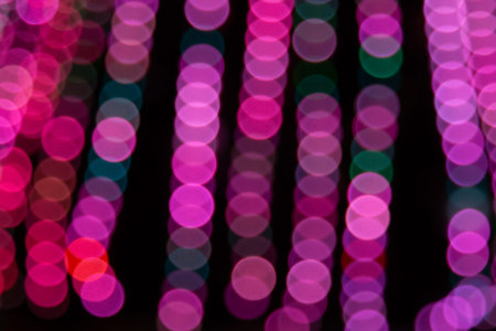 Golden abstract yellow, orange bokeh lights isolated on black background with copy space. Holiday...