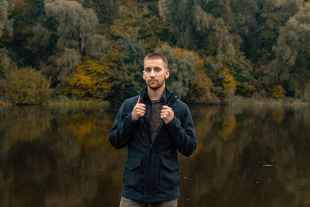 Closeup portrait of a guy on a lake background. rest, calm
