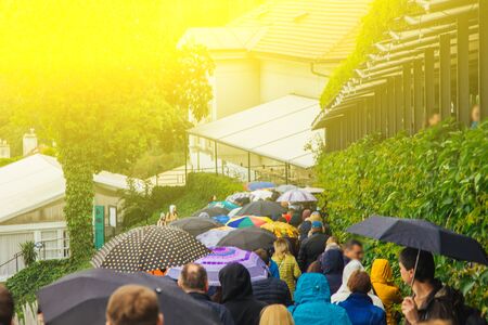 Czech Republic. Prague - May 5, 2019: a crowd of people walking with umbrellas in heavy rain down the street. Excursionの写真素材