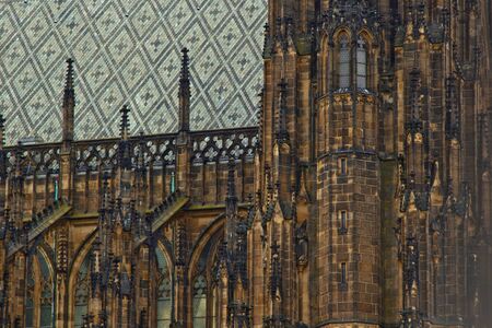 Prague. 05.10.2019: Perspective view of the Metropolitan Cathedral of Saints Vitus, Wenceslaus and Adalbert, an excellent example of Gothic architecture. Golden Gate South Tower with clockの写真素材