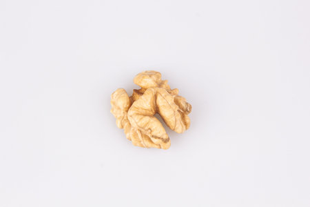 Half a walnut isolate. Peeled walnut on white. Walnut top view. Set with clipping path. Full depth...