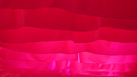 Light flowing red fabric imitating waves. The concept of lightness, female beauty, tenderness. air show. Association with women's critical daysの写真素材
