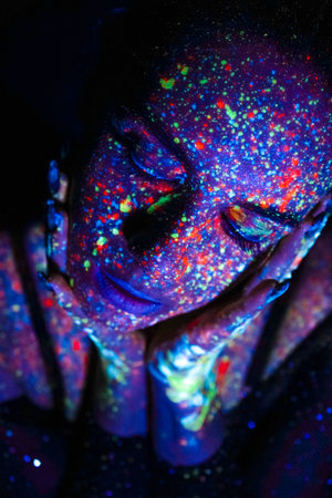 Model woman in neon light, beautiful model girl with fluorescent makeup, art design of disco dancer...